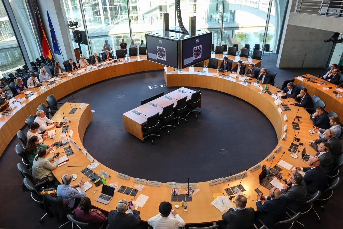 Participants seated around a large circular table during a European Commission working meeting in Berlin.
